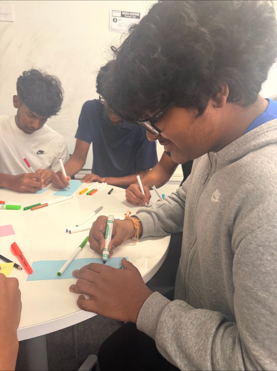 Members coloring cards around a table